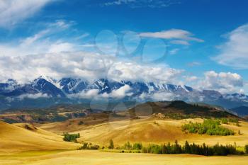 Landscape with snowy mountains and blue sky