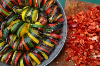 Ratatouille. Vegetable dish. Peasant food. Vegetables, cut into slices. Zucchini, pepper, tomato, eggplant. Recipes. Delicious. It is useful. Close-up. Horizontal photo