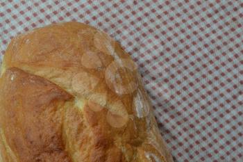 Bread. A loaf of bread. Freshly baked bread. Food. Kitchen. Tablecloth. Delicious. Close-up. Horizontal