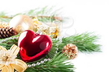 Christmas background with red heart, decorations and pine branch