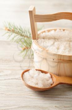 Aromatic bath salt in wooden bucket and spoon