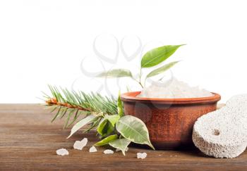 Aromatic bath salt and pumice stone on a wooden background