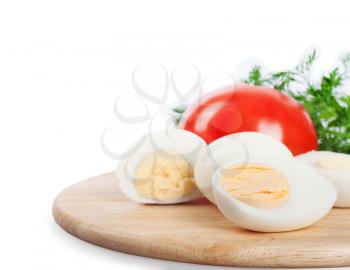 Boiled hen eggs, green dill and tomato on a white background