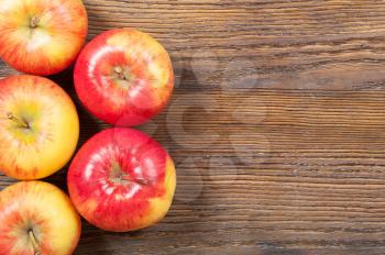 Ripe red apples on a wooden background. Top view.