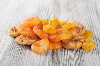 Dried fruits on a wooden background. Candied fruits, lemon, apricot, figs. 