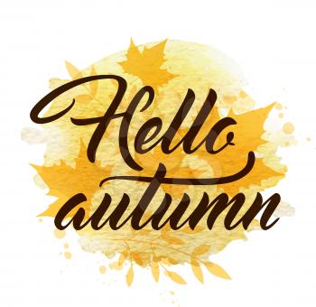 Abstract autumn background with yellow falling maple leaves. Hello autumn lettering and yellow watercolor blots.