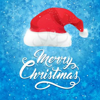 Blue Christmas background with hat of Santa Claus. Merry Christmas lettering. Design for Christmas card.