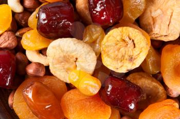 Bright abstract food background. Dried fruits, dates, lemon, apricots, figs and nuts. 