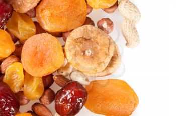 Dried fruits, dates, lemon, apricots, figs and nuts on a white background. 