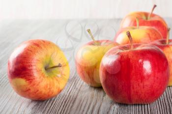 Red ripe apples on a wooden table