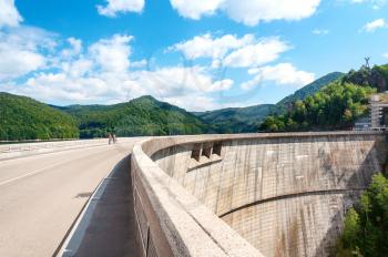 Vidraru dam on Arges river in Transylvania, Romania.  Fagaras ridge in the Carpathian mountains. Hydro electric power station