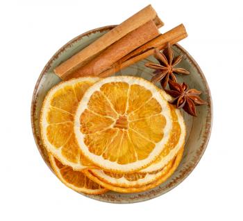 Dried orange slices, cinnamon and star anise in a plate. Spices for mulled wine isolated on a white background. Top view