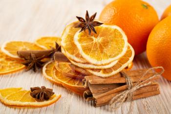 Dried orange slices, cinnamon and star anise on a wooden background. Spices for mulled wine and winter decoration. 