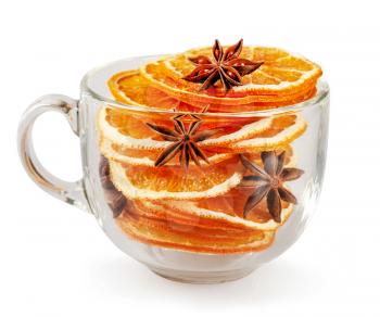 Stack of dried orange slices, cinnamon and star anise in a glass cup. Spices for mulled wine on a white background.