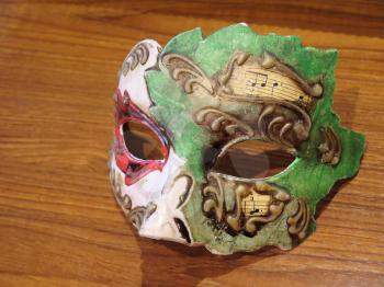 Venetian carnival mask on wooden background