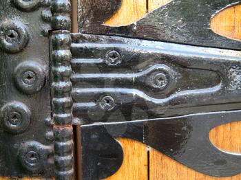 Very old ironwork hinges at wooden blinds