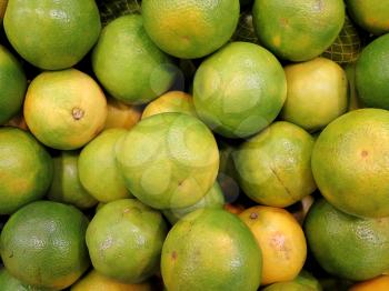 Closeup of fresh green oranges, delicious tropical fruit