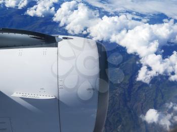 Engine of the plane on blue sky and clouds background