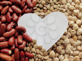 White Heart shape on Raw Red Beans, lentils and chickpeas Background. healthy food