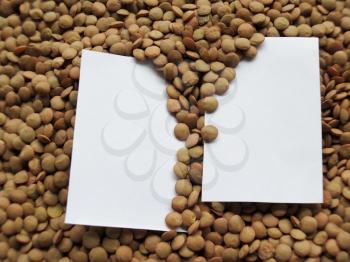 White tag on Heap of raw lentils background