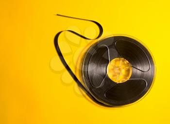 The obsolete media carrier is a musical reel on a retro yellow background