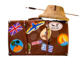 Old battered suitcase seasoned traveler with stickers from various countries he visited tropical helmet and broken through arrow. Isolated on White