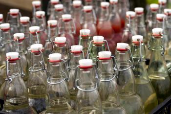 rows of bottles with homemade alcohol apart for street parties
