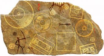 Piece of stone with ornament depicting prehistoric cave paint with hunters animals and floppy disk, tape, and the plate