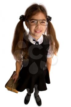 A little schoolgirl in glasses holds a stack of old books tied with a rope and looks up her head
