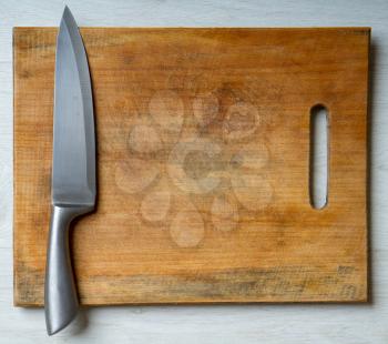 wood cutting board and sharp steel knife top view