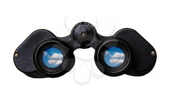 Old black binoculars view from behind in which a blue sky and clouds can be seen