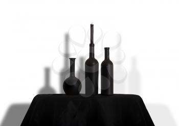 dark black bottles and candles on a black tablecloth. Halloween party