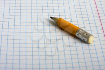 small stub of a pencil lying on a school notebook in a cellule