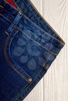 Classic new blue jeans front pocket close up on a light background