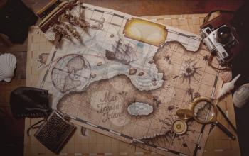 background of old maps, cameras and other small things for travel on a dark wooden background