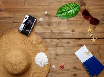 top view set of women's beach accessories and things for relaxation on a wooden brown background