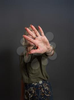 Adult woman shows stopping or prohibiting gesture with hand