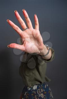 Adult woman shows stopping or prohibiting gesture with hand