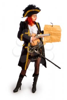 sexy girl in a pirate costume and a cocked hat stands on a white background and shows something on the map with a gun