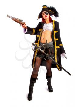 sexy girl in a pirate costume and a cocked hat stands armed with a pistol on a white background in high heels
