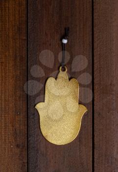 protective amulet Fatima Hamsa's hand without a picture hanging on a rough wooden door