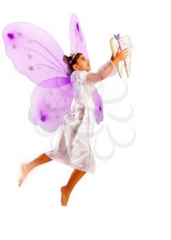 Little fairy tooth fairy with bright wings rejoices in the received baby milk tooth