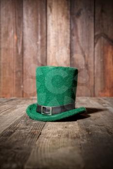green classic leprechaun bowler hat on old wooden table in a pub