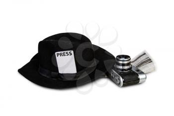 old classic fedora hat with attached press badge and film camera on white background
