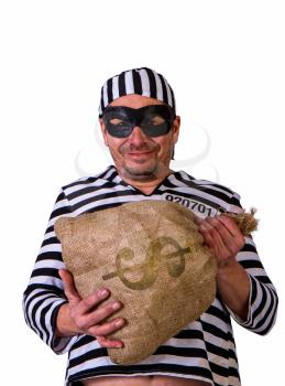 funny operetta gangster in a striped prisoner costume and a black mask with a bag of dollars on a light background isolated on white background