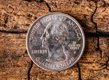 quarter american dollar with  George Washington coin closeup on old wooden surface