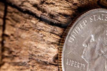 quarter american dollar with  George Washington coin closeup on old wooden surface