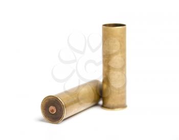 two old brass shot cartridges of a twelfth caliber hunting rifle on a white background