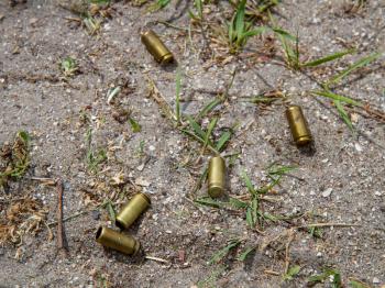 several pistol shells scattered after firing on the ground
