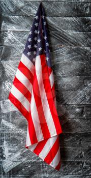 beautiful starry striped flag of united states of america on dark wooden background